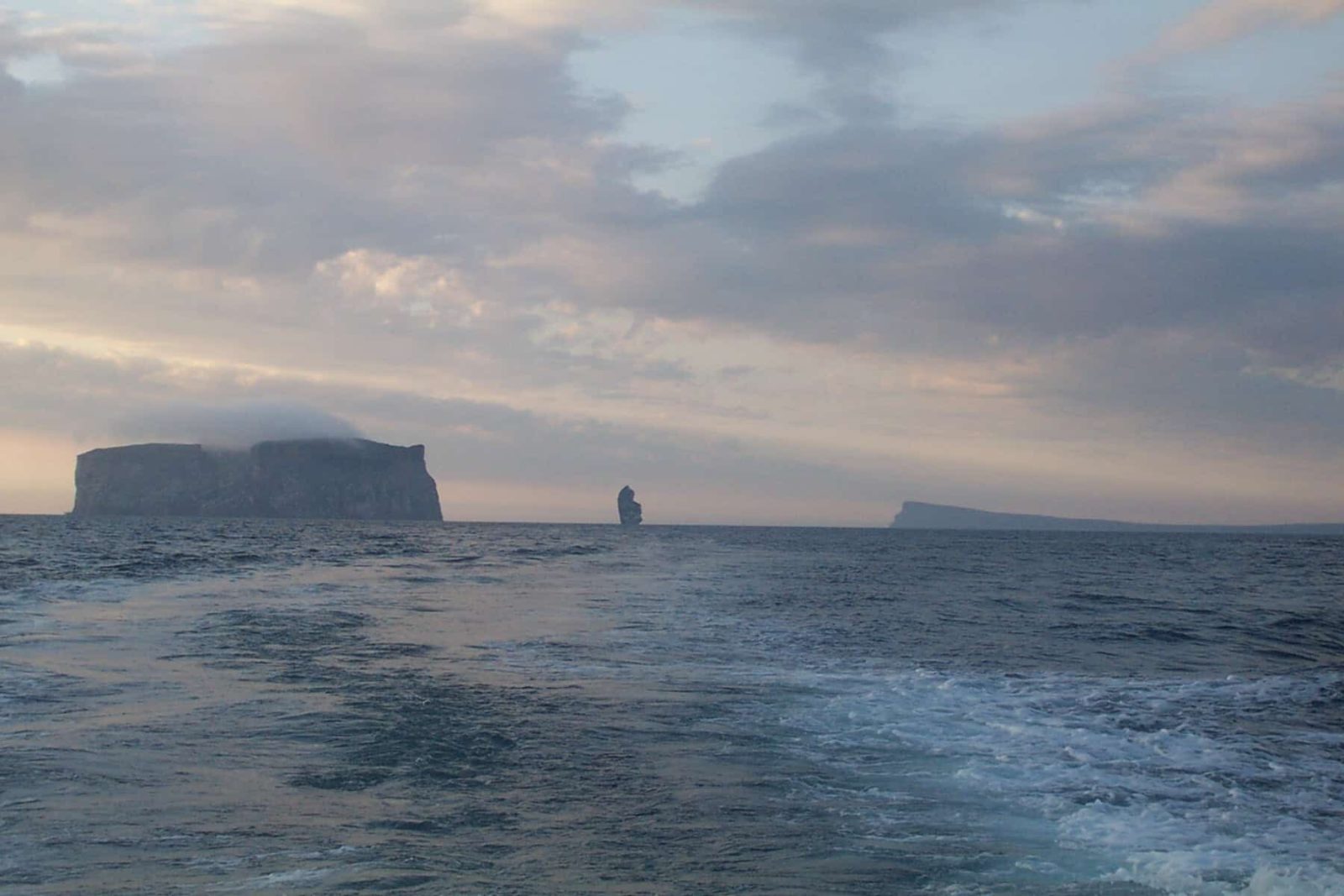 Twilight in the fjord of Skagafjörður in the northwest of Iceland. Drangey island on the left. The stone stack Kerling in the middle and the island of Málmey on the right.