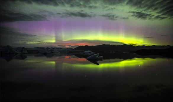 Northern lights over the Jökulsárlón glacial lagoon, a glow from the holuhraun eruption is also visible. Photo by German Photographer Martin Schultz. This veteran photographer is the perfect man to create the ultimate guide to photographing Iceland.