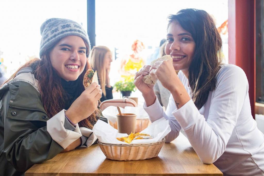 Women eating tacos at Hlemmur food hall in Reykjvik, Iceland