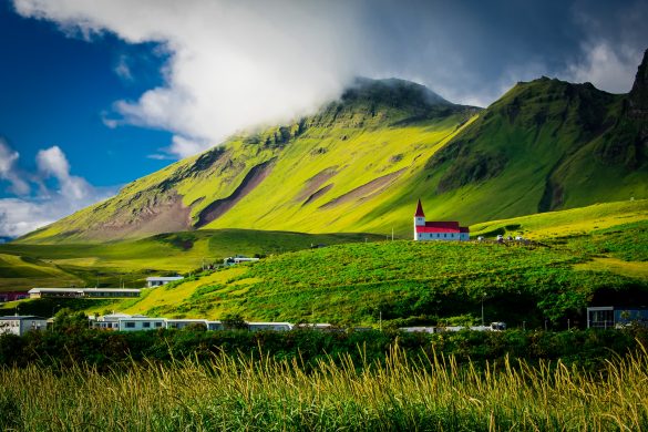 Enjoy the best of Iceland on a budget. Here is the church in Vík in summertime.