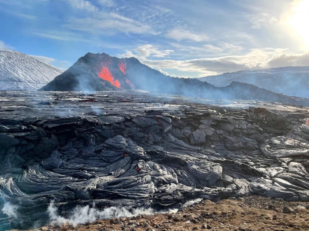 Volcano erupting with lava field in the foreground. Picture from Iceland.