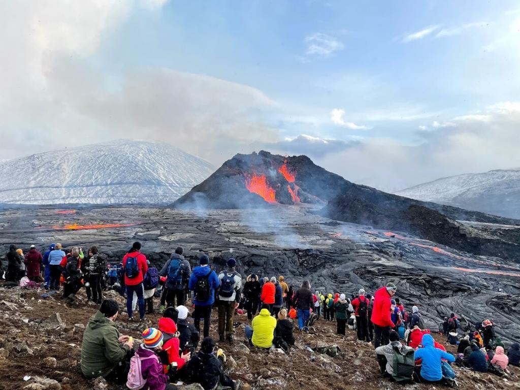 People watching a volcano in Iceland.