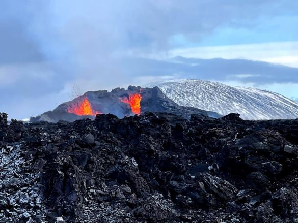 Volcano with new lava in front of it.