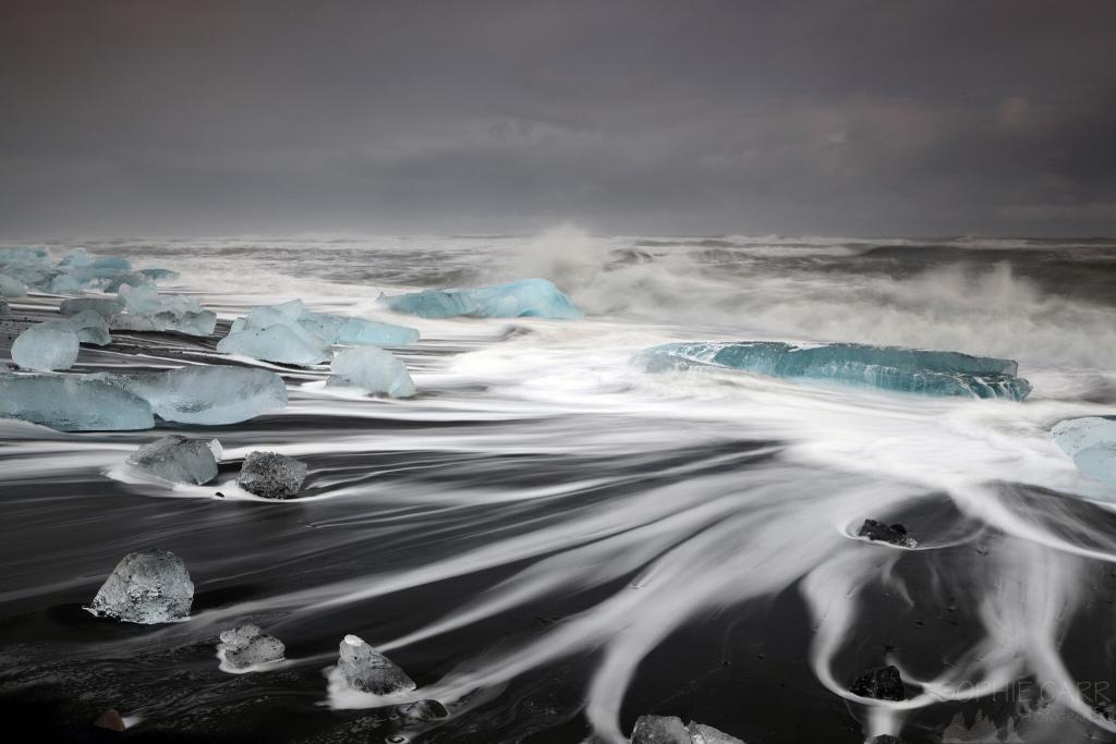 Icebergs in the waves on Jökulsárlón beach, in south-east Iceland.