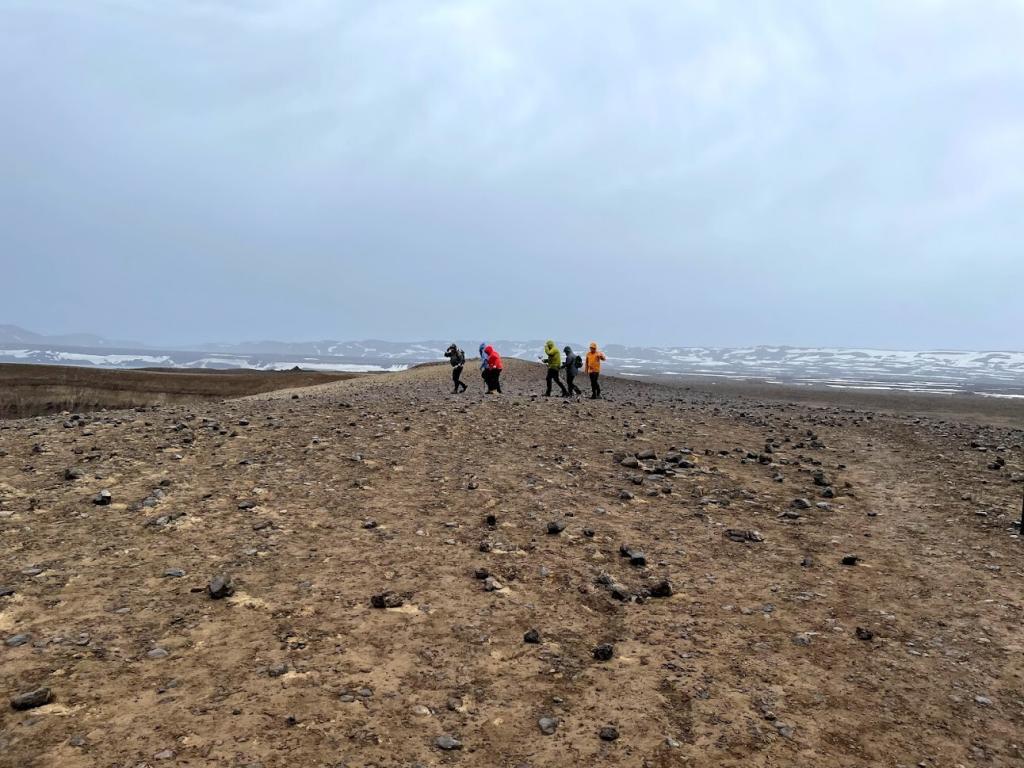 people walk in bad weather in the Icelandic highlands. Their destination is Lake Askja and the Víti lagoon.