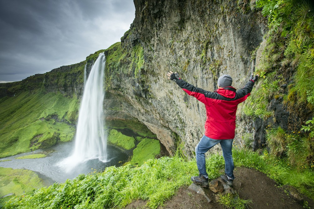 Man at the Seljalandsfoss waterfall in Iceland.