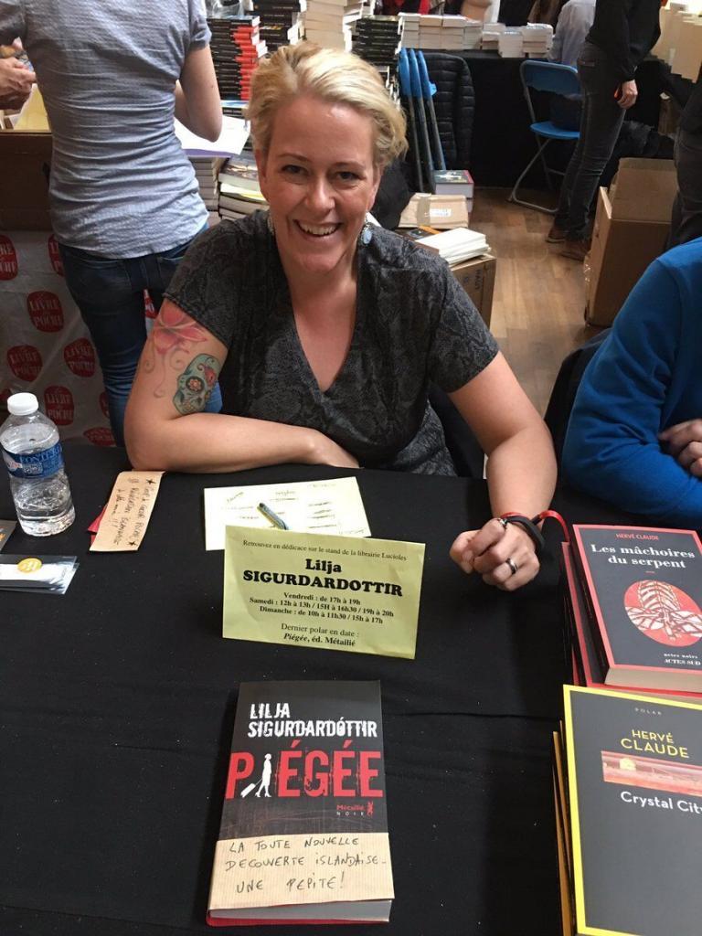 Lilja Sigurðardóttir signing at a book festival in France.