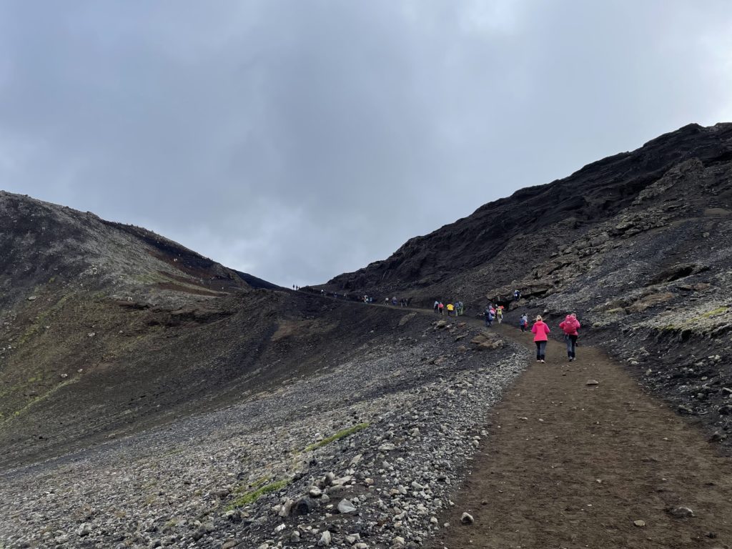 People hiking towards the volcanic eruption in Iceland in 2022.