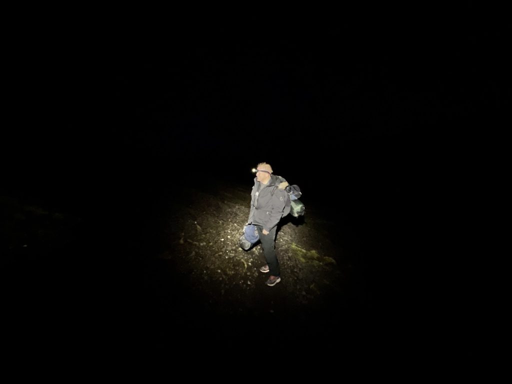 Man hiking with headlamps in Iceland