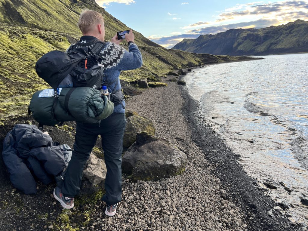Jón Heiðar Ragnheidarson, the editor of Stuck in Iceland takes a photo at lake Langisjór in the Icelandic highlands.