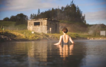 Bathers relaxing in the geothermal Secret Lagoon (Gamla Laugin) in Flúðir, Iceland — save 15% with the Stuck in Iceland promo code.