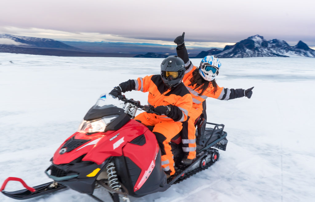 Couple on a snowmobile on Langjökull glacier in Iceland