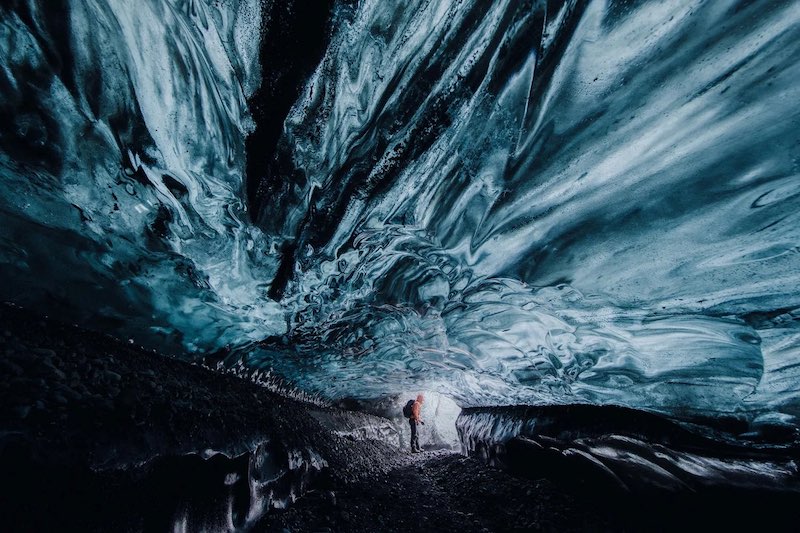 Man inside an ice cave in Iceland.