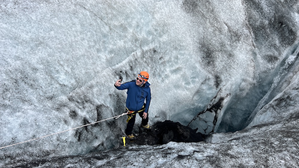 A man takes a selfie at the edge of a bottomless crevasse in the Sólheimajökull glacier in Iceland.