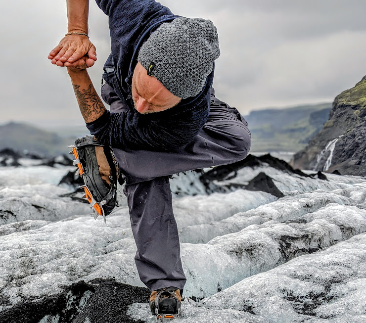 Man performs yoga on an Icelandic glacier.