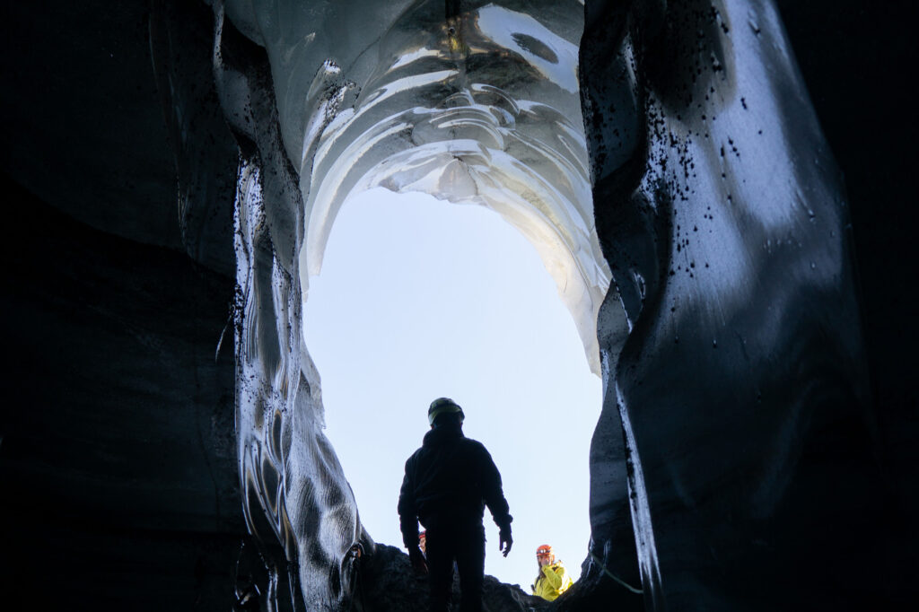 Man in an ice cave in Iceland.