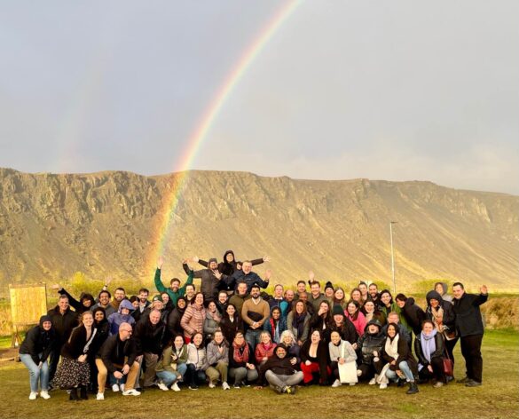 The Skift team under a rainbow in Iceland.