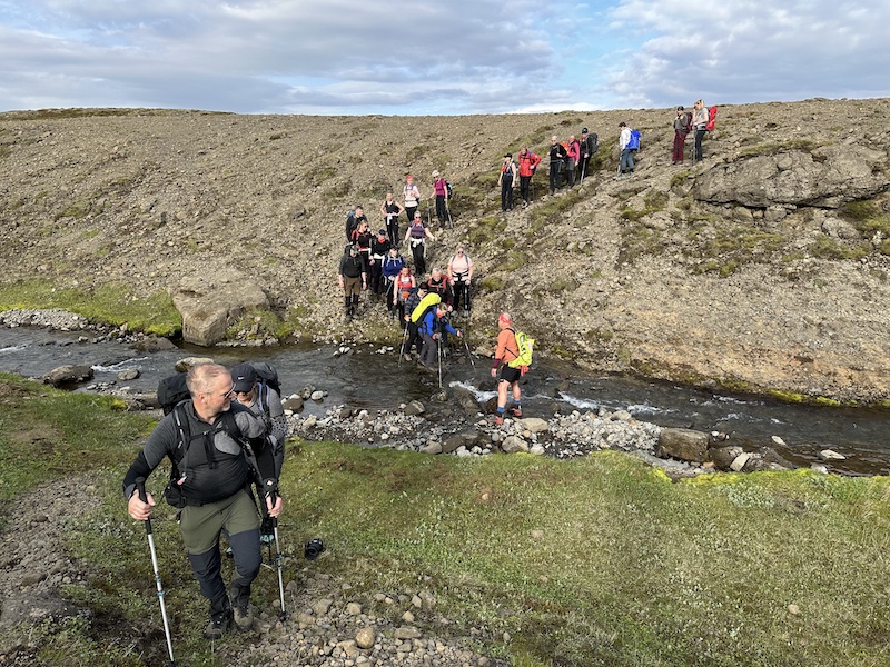 Getting over a stream is a team effort. This stream is on the Leggjabrjótur hiking trail in Iceland.