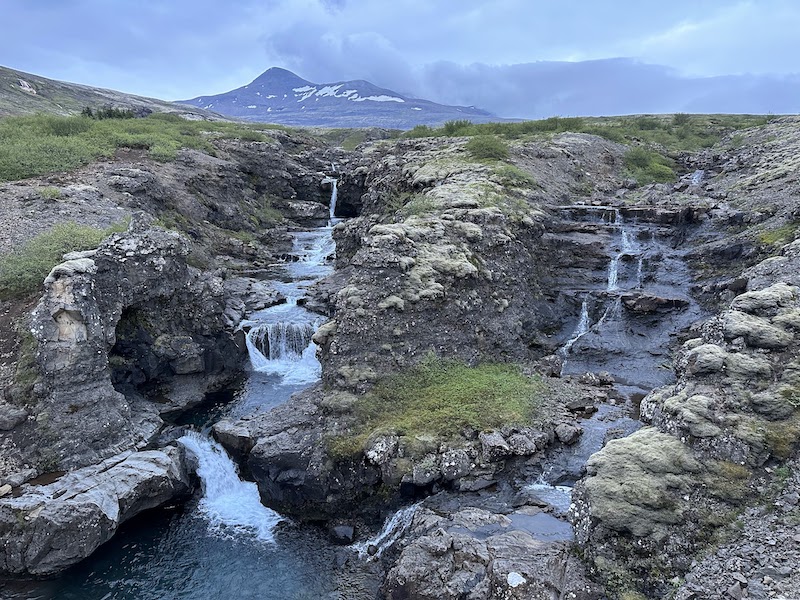 The beautiful waterfall in Fossá in Botnsdalur in Hvalfjörður fjörd. Mt. Botnssúlur in the background.