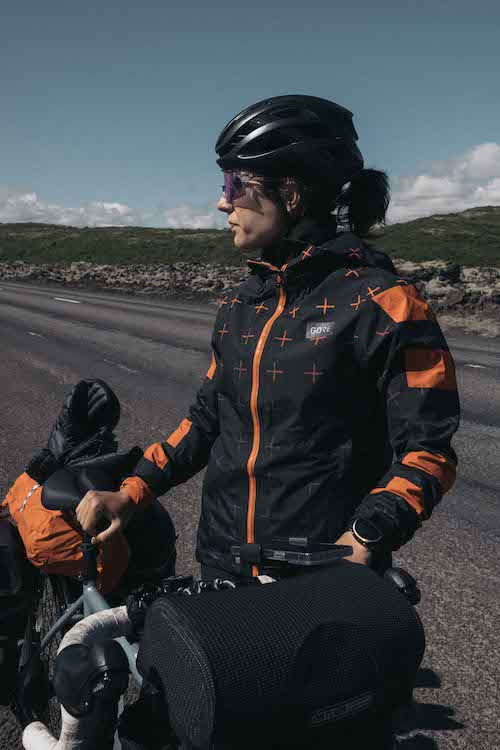 A woman by her bike in Iceland.
