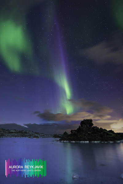 The northern lights shimmer above the Blue Lagoon in Iceland.
