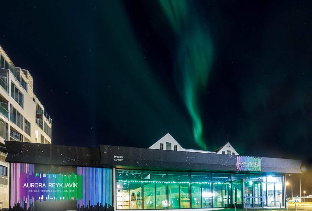 The northern lights light up the winter sky above the Aurora Reykjavik Northern Lights Center.