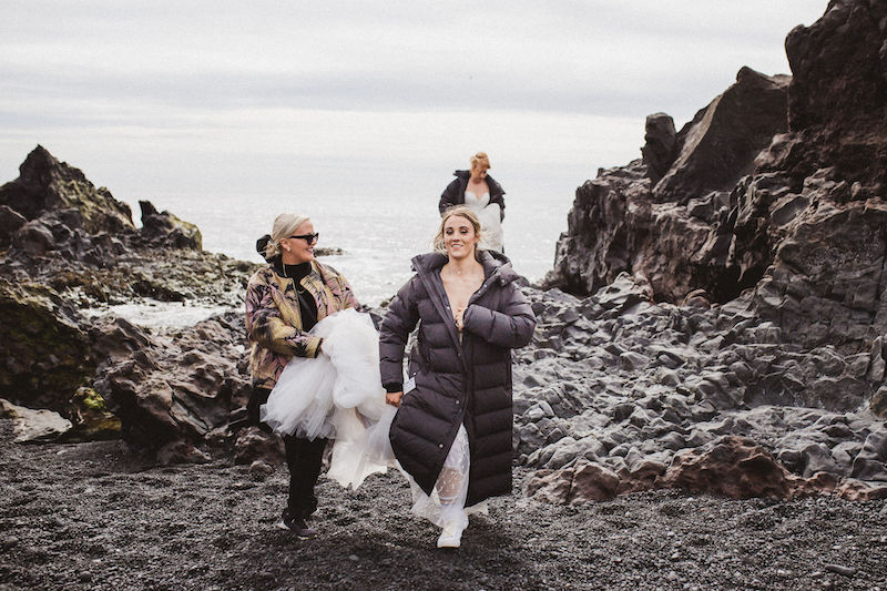 A woman assisting a female couple getting married