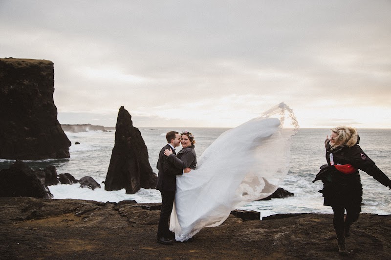 Newlyweds caught in a wind in Iceland.