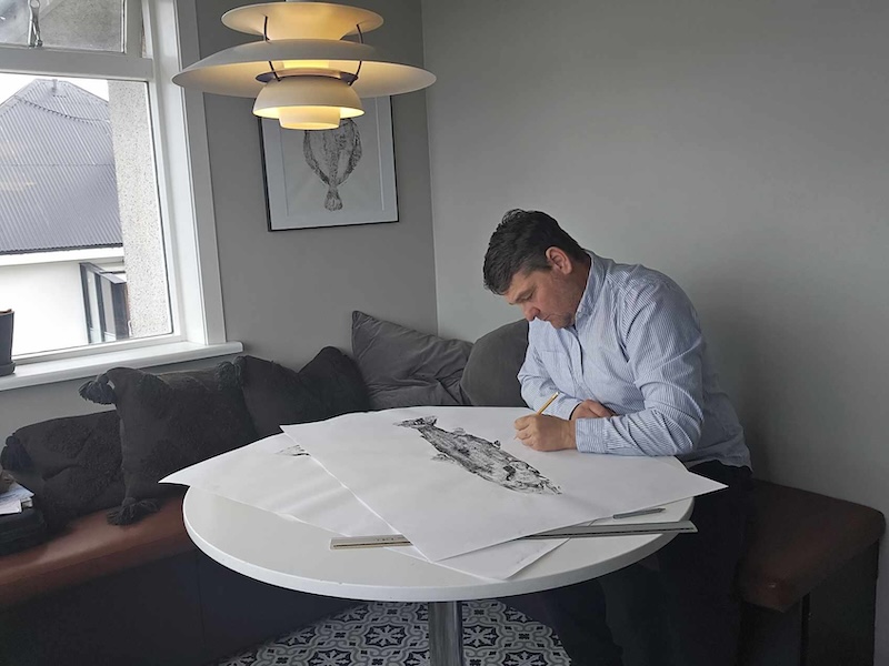 Man drawing a gyotaku fish print.