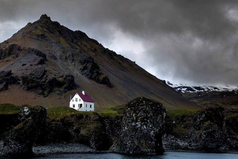 A white house with a red roof in the Westfjords, in Iceland