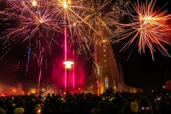 People are shown celebrating the new year at Hallgrímskirkja Cathedral in Reykjavik, Iceland.