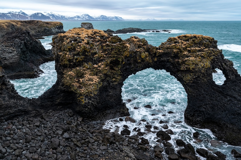 Close-up of the beautiful Gatklettur rock arch in late winter, at the black basalt cliffs of Arnarstapi on the south coast of the Snæfellsnes peninsula, Iceland
