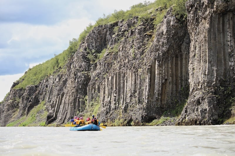 See the beautiful basalt columns on the banks of the Hvítá river from the river.