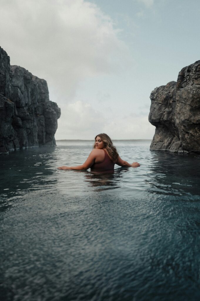 A lady soaking in the waters of the Sky Lagoon spa. Photo by Karsten Winegeart on Unsplash