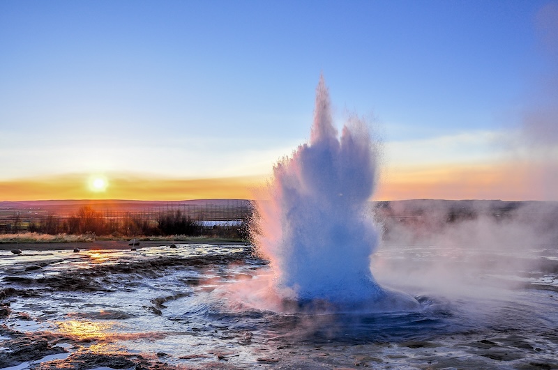 Geysir erupts on the Golden Circle in Iceland in the twilight—photo by Ondrej-Bucek on Shutterstock.