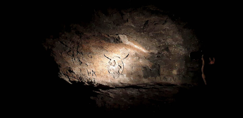 The Caves of Hella are full of mysterious and ancient carvings.