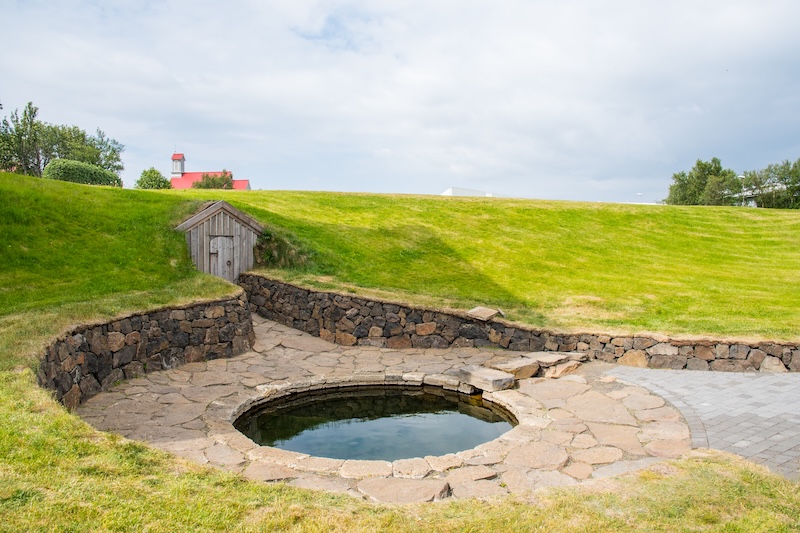 Snorralaug pool in Reykholt, Iceland, a historic hot spring used since medieval times and connected to Snorri Sturluson, an important cultural stop on the Silver Circle route.