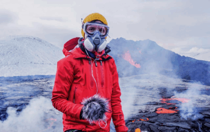 Kaśka Paluch recording natural sounds during the Fagradalsfjall volcanic eruption in Iceland. Wearing protective gear, she captures raw Icelandic soundscapes for her Noise From Iceland project.