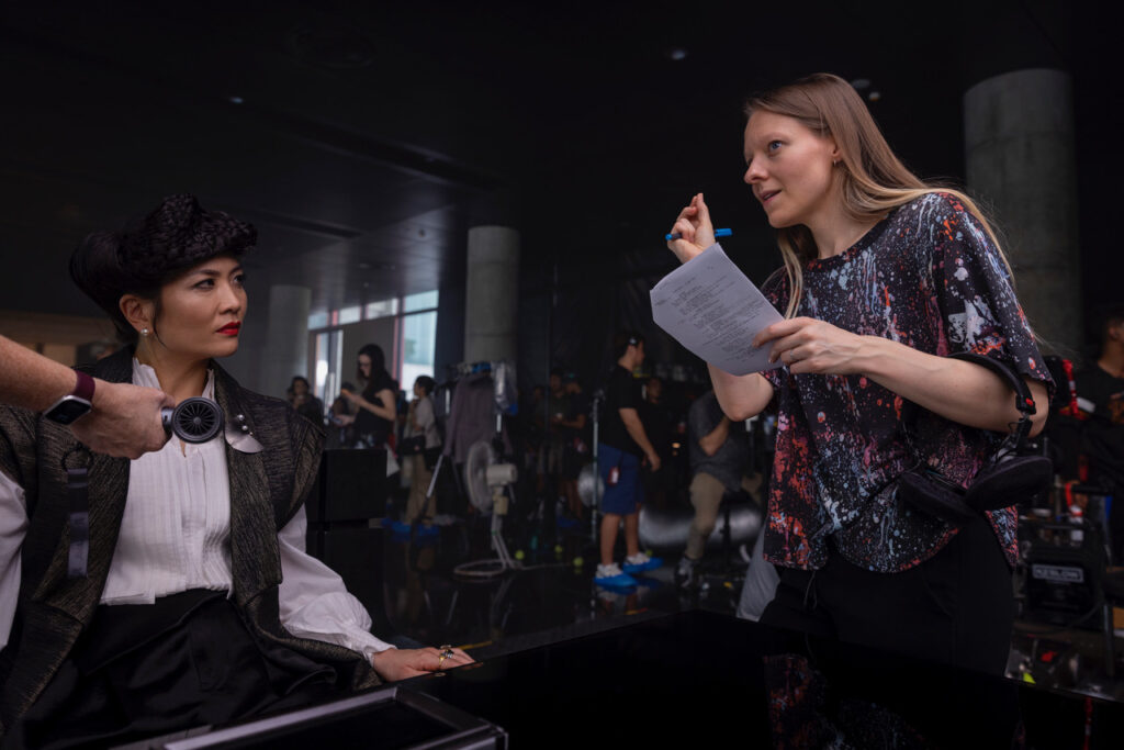 Ugla Hauksdottir directs Sandra Yi Sencindiver on the set of Alien Earth. Sencindiver plays the ruthless billionaire Yutani — the arch-nemesis of Boy Kavalier in this bold new chapter of the Alien universe.