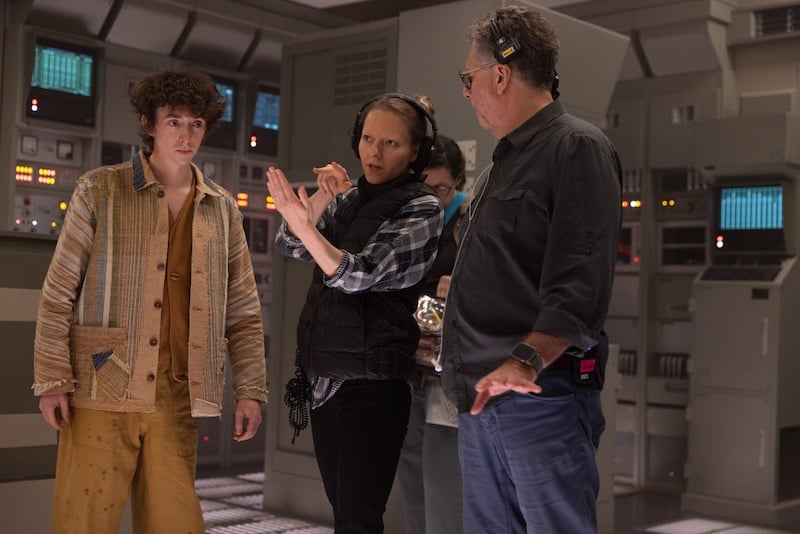 Director Ugla Hauksdottir gives direction to actor Samuel Blenkin on the set of Alien Earth, inside a futuristic control room setting.