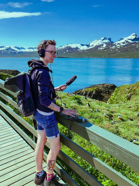 Kaśka Paluch recording Icelandic soundscapes near a puffin colony on the coast, surrounded by mountains and ocean. Field recording for her Noise From Iceland project.