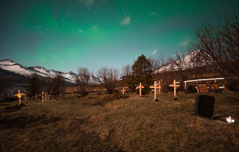 An Icelandic cemetery illuminated by the Northern Lights — a hauntingly beautiful reminder of Icelandic Halloween traditions and the country’s deep connection to folklore and the supernatural.