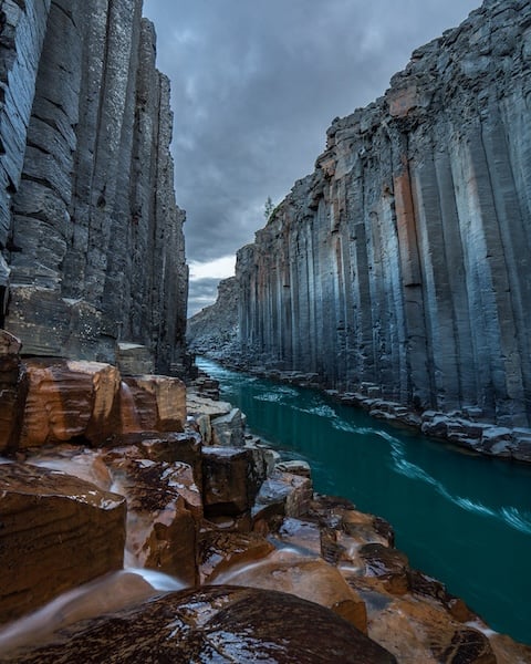 Stuðlagil canyon basalt columns and turquoise glacial river East Iceland - photographed by Rico de Jong.