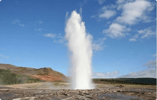 Strokkur geyser erupting in the Haukadalur geothermal area on Iceland’s Golden Circle, a must-see stop on an Iceland road trip vacation.