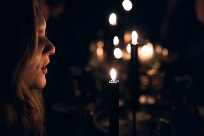 Guest listening to stories by candlelight at Viking Story Night.C
