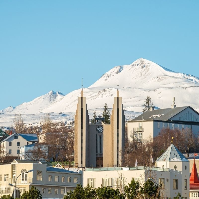 Akureyrarkirkja church with snow-capped Mt. Súlur rising behind it on a clear winter day in Akureyri, North Iceland.