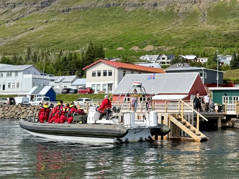 Fjarðaferðir RIB boat with guests in red suits leaving the pier at Neskaupstaður